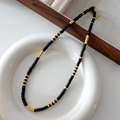 Tiger eye beaded necklace with black cylindrical beads and gold metal accents - Obsidian Necklace XL0280