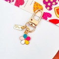 Colorful enamel five-petal flower keychain with handmade metal tag on white background - Colorful