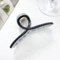 Detail view of large resin shark hair claw clip with blue bubble decor and non-slip teeth - Black-11cm