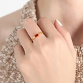 Slim gold-plated ring with a rectangular red gemstone, displayed on a model hand - Gold Red Zirconia