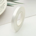 White balloon ribbon roll on a decorative plate with fresh green botanical elements - 10m*4mm / White