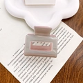 Pink and grey rectangular acetate hair claw clip displayed on a white ceramic plate - Light Gray