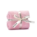 Pink coral fleece towel rolled as a gift with cream ribbon bow on white background - Pink