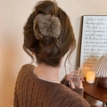 Elegant plush faux fur hair scrunchie in coffee brown shown on a model's low bun hairstyle - Deep Coffee Hair Claw