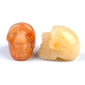 Polished 1-inch natural crystal skull carvings in orange and yellow gemstone colors - Topaz