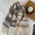 Striped winter scarf in beige and grey with soft fringe details on a cozy tray setting - Khaki