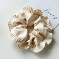 Detailed macro view of champagne satin scrunchie with pleated edges and premium texture - Creamy White Ruffled Scrunchie