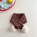 Close-up of a brown knit scarf for children with floral jacquard and white pom-poms - Coffee & Beige Striped Floral