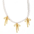 White oval pearl necklace featuring three elegant golden bow pendants in 18K gold finish - Gold