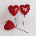 Three bright red heart-shaped cake toppers with long wire stems on white fabric - 60mm (Single)