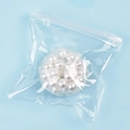 Detailed macro shot of white squeeze stress balls in a transparent zip-lock bag - White Pearl / 6cm