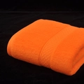 Bright orange pure cotton bath towel with textured jacquard border on black velvet - Orange Yellow