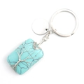 Detail of square turquoise stone keychain with silver wire-wrapped tree of life design - Synthetic Turquoise