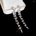 Macro shot of silver zircon fringe earrings featuring square-cut sparkling crystals - Silver