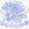 Macro detail of light blue translucent moon and star glass beads with gold foil for DIY jewelry - Light Blue Gold Sprinkled