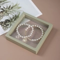 Elegant white pearl bracelets with gold D-charm and compass in a square green display box - 11x11cm / Fruit Green