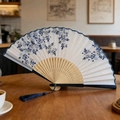 Classic folding fan with blue floral pattern and wooden ribs with dark blue tassel - Blue White Porcelain Style