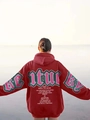 Macro detail of green STURDY lettering print on a burgundy oversized street hoodie - S / Burgundy