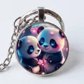 Round metal keychain featuring a cute cartoon panda design with pink hearts - Two Cartoon Pandas Snuggling