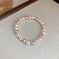 Detail of pink and white faux pearl bracelet on beige fabric with thank you card - 73# Bracelet-Two Tone Pearl-White/Pink Orange