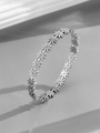 Detailed close-up of a silver daisy bracelet with rhinestones and fine metal texture - Daisy / Steel