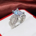Elegant silver ring with emerald-cut zirconia and pave-set crisscross hollow band - Ur0668