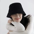 Detail of adjustable black corduroy bucket hat worn by a model in a studio setting - Adjustable / Black