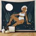 Close-up of bohemian wall tapestry featuring tattooed woman under full moon in a desert - Mld217