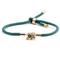 Adjustable green cord bracelet featuring a gold elephant charm with inlaid zircon stones - Green Elephant