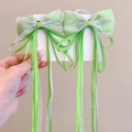 Detail of light organza bow hair clips in green and white with long flowing ribbons - One Pair / Fruit Green