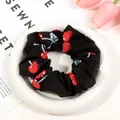 Classic plaid scrunchie in black fabric featuring red cherry prints for ponytails - Black Cherry Scrunchie