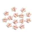 Macro detail of pink star-shaped evil eye beads with golden edges and enamel finish - Pentagram / Pink