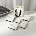 Minimalist beige jewelry gift box set with black ribbon handles and elegant packaging - Black Jewelry Box / 7X7X3cm