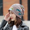 Coffee brown beanie with vibrant feather print design and soft knitted texture - Standard / Dreamy Feather Khaki