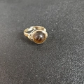 Detailed macro view of handmade gold wire-wrapped ring with a round brown natural gemstone - Adjustable Open / Tiger Eye