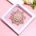 Detailed close-up of golden snowflake brooch with pearls and rhinestones in gift box - XZ097-Snowflake Pearl-Boxed