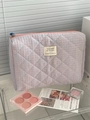 Detail view of quilted blue checkered cosmetic bag with woven label and orange zipper - Handbag (Medium) / Pink