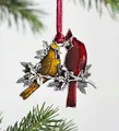 Detail of Christmas tree ornament featuring two colorful birds on a silver metal frame - Double Birds