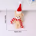 Detail view of 20cm plush teddy bear wearing a red Christmas hat and striped scarf - 15-18cm / Christmas Teddy Fleece Red White Scarf