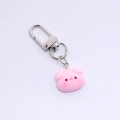 Close-up of a cute pink resin pig charm attached to a silver metal D-ring keychain - Pink Pig