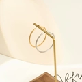 Detail of gold and silver textured hoop earrings featuring a diamond cut finish - 30MM / Steel