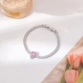 Macro shot of a silver bracelet featuring a pink teardrop zircon and pavé crystals - Silver Waterdrop Style