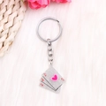 Macro detail of glitter poker card keychain with a pink 3D heart and silver ring - Silver Poker