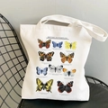 White canvas tote bag featuring colorful British Butterflies print on a vintage chair - British Butterflies Guide (STD344-Q)