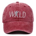 Detailed close-up of white WILD embroidery with sasquatch on washed burgundy baseball cap - Adjustable / Burgundy