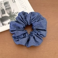 Elegant blue denim scrunchie with rose embroidery on a rustic wooden background - Solid Dark Denim