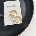 Transparent amber resin C-shape hoop earrings on a minimalist display card - Bright Yellow