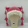 Detail of pink striped crochet cat ear hat with white faux fur trim and star tassels - Rose Pink Striped