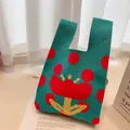 Knitted tote bag with green base and large red floral pattern on an open magazine - Cyan with Rose Red Polka Dots