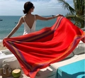 Detail view of a red bohemian beach shawl with ethnic patterns against a sea background - Red Base Geometric Border (Ethnic Style-18)